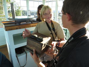 Pam showing Levi how heavy telephones used to be.