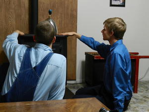 Daniel and Isaac checking out Dads pellet stove