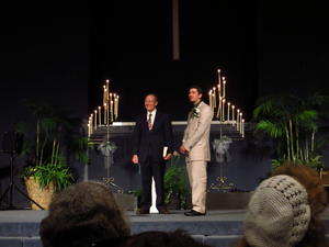 The groom Eleazar, and Pastor Fred watching as the wedding party lined the walkway.