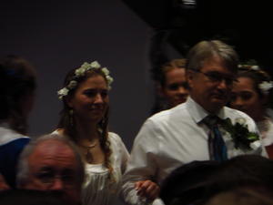 The bride marched in between all her bridesmaids and then they followed her up the aise.