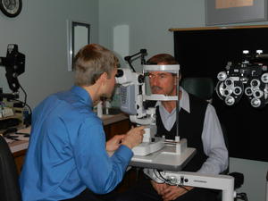 Daniel learning how to look at Dad's eye through the slit lamp.
