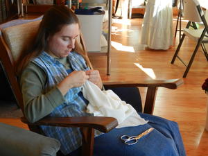 Kimberly finished sewing the wedding dress, and Claude isn't pictured because he spent the day running errands and working outside.