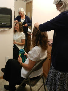 The bride getting her hair fixed.