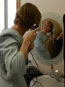 Kristina putting a quick touch to her hair before starting the prelude music at the piano.