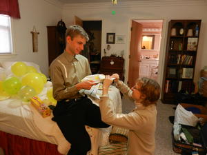 Daniel and Kristina helping wrap gifts for a surprise birthday for Mark.